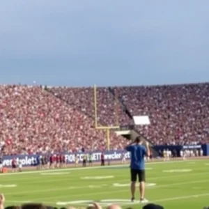 College football stadium filled with cheering fans.